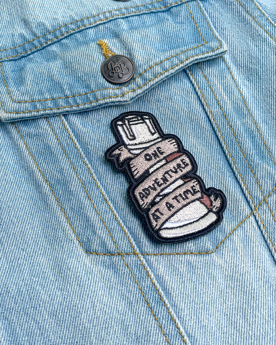 ADSOM patch of a rook with a banner wrapped around it featuring the quote &