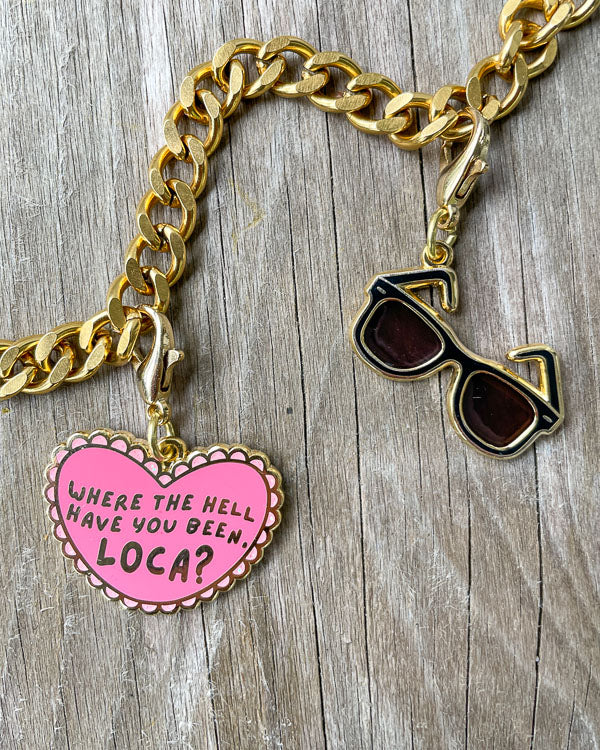 Twilight charms featuring a pink heart with the quote 'Where the hell have you been, loca?' written in it and Edward's sunglasses.