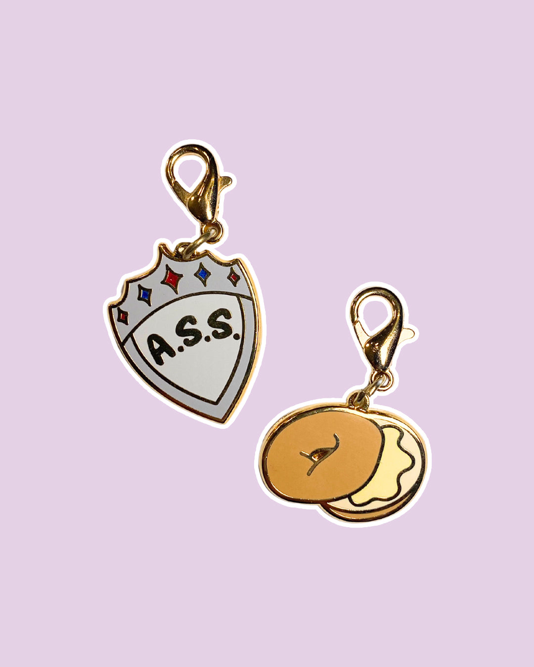Zodiac Academy charm set featuring an A.S.S. shield and a bagel.