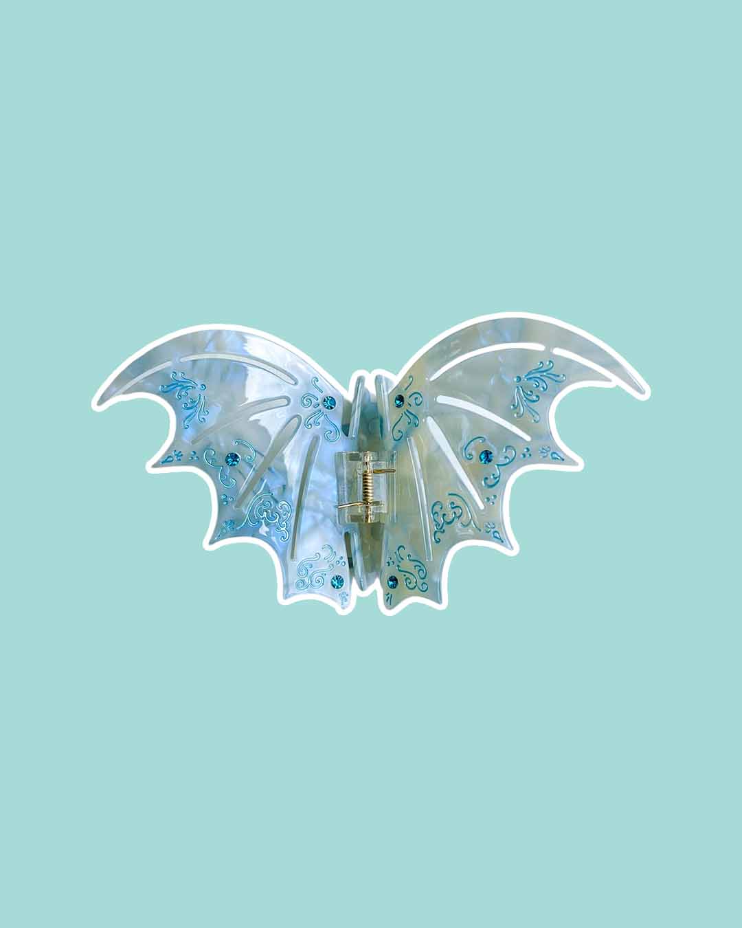 ACOTAR-inspired bat boy hair claw clips in pastel blue with etching details and blue gem embellishments for Sarah J. Maas fans.