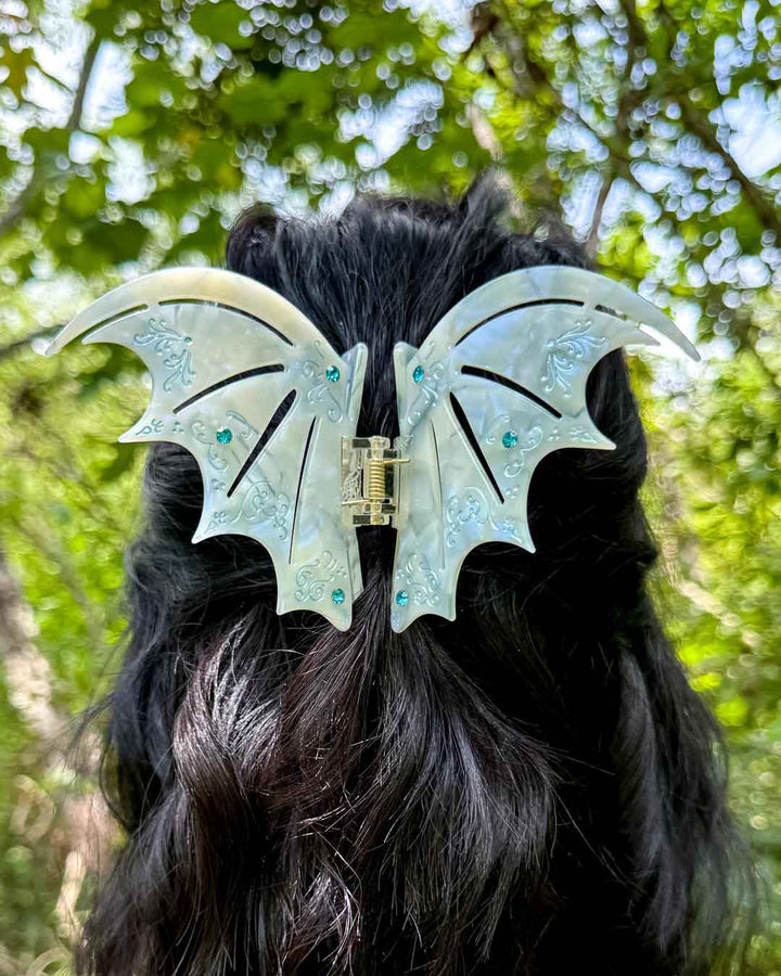 A dual-tone hair clip in pastel blue with blue gem embellishments inspired by the bat boys from A Court of Thorns and Roses by Sarah J. Maas. 