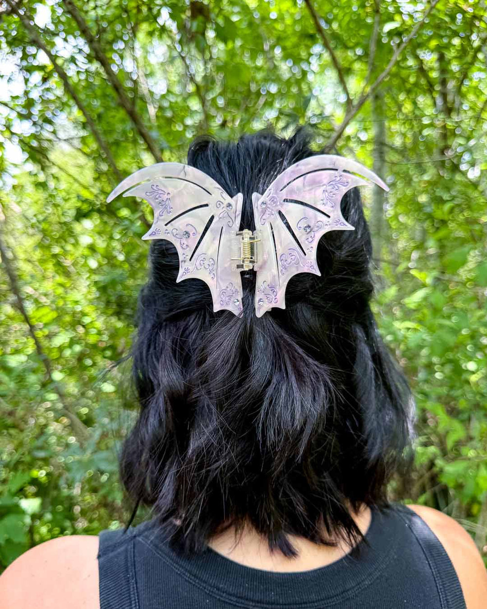 A dual-tone hair clip in pastel purple with purple gem embellishments inspired by the bat boys from A Court of Thorns and Roses by Sarah J. Maas. 