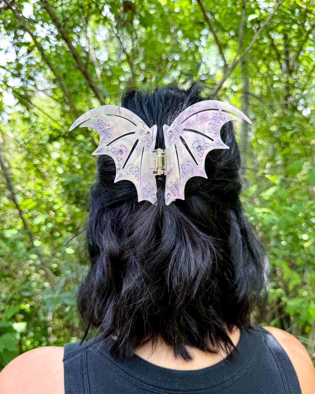 A dual-tone hair clip in pastel purple with purple gem embellishments inspired by the bat boys from A Court of Thorns and Roses by Sarah J. Maas. 