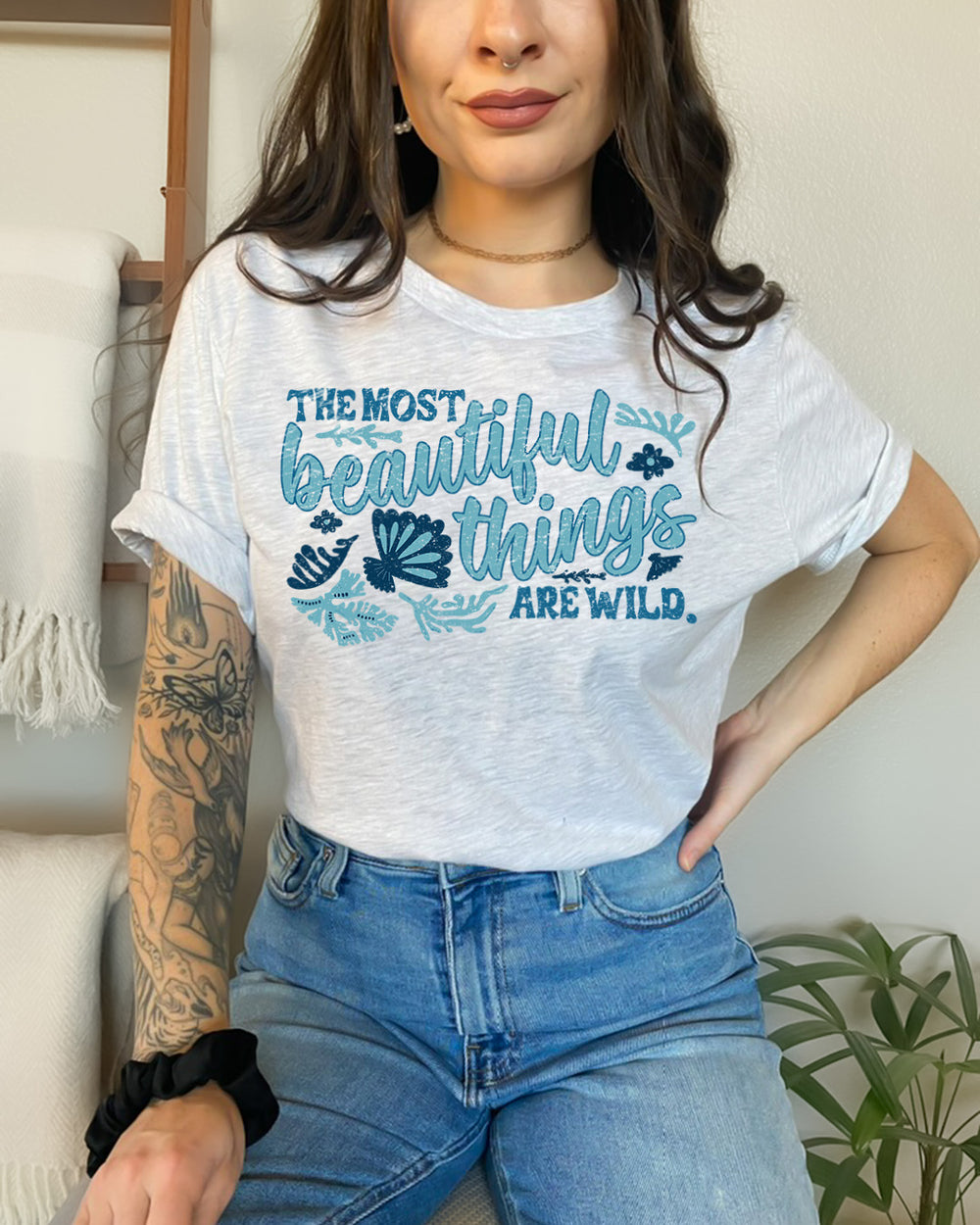 Bookish shirt with a design for the quote 'The most beautiful things are wild' from Bring Me Your Midnight by Rachel Griffin.