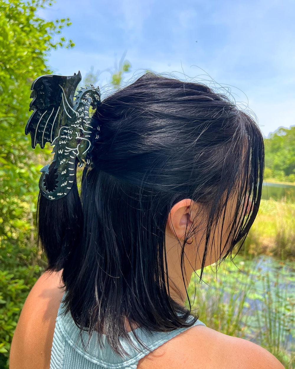 A black and silver detailed bookish hair clip for fantasy lovers in the shape of a dragon.