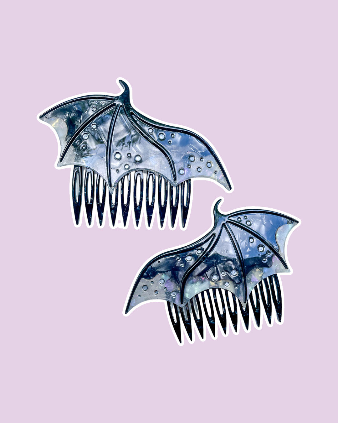 Dragon wing hair combs for fantasy fans in black featuring engraved embellishments and a pearlescent black color.