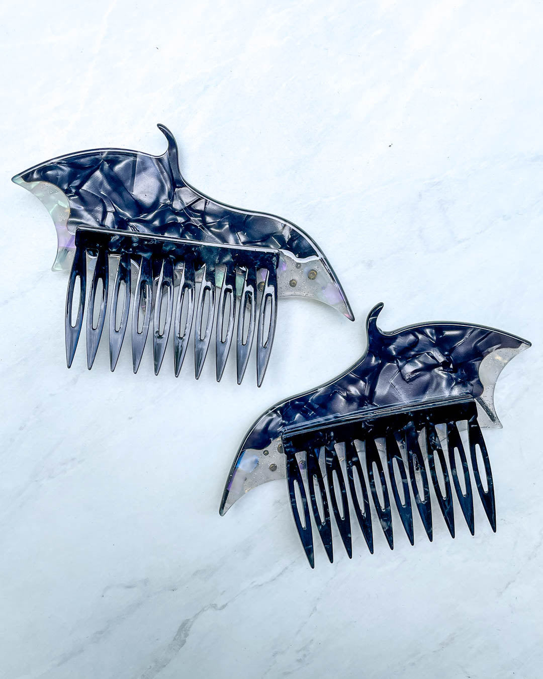 Back of the dragon wing hair accessories featuring a set of black hair combs and a pearlescent color.