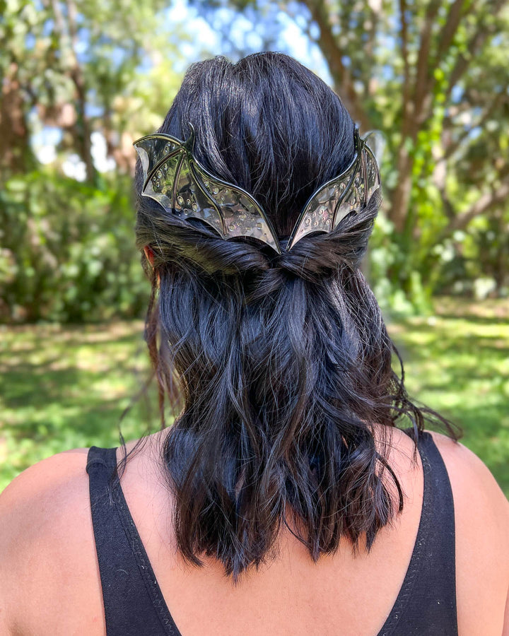 Hair combs for dragon lovers featuring two large combs in the shape of dragon wings with engraved details and a pearlescent black color.