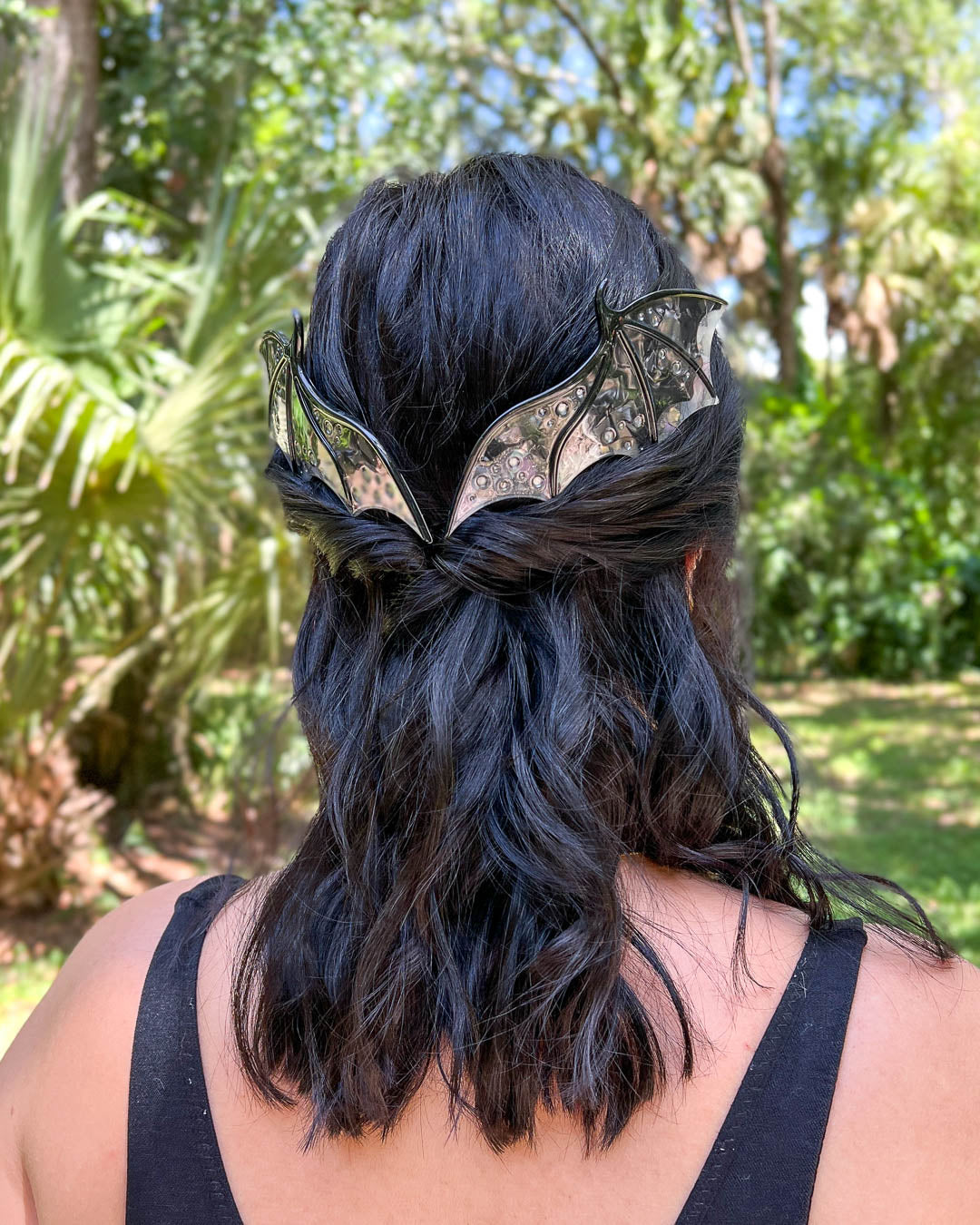 Fantasy hair combs featuring large combs in the shape of dragon wings in black with engraved embellishments and a pearlescent color.