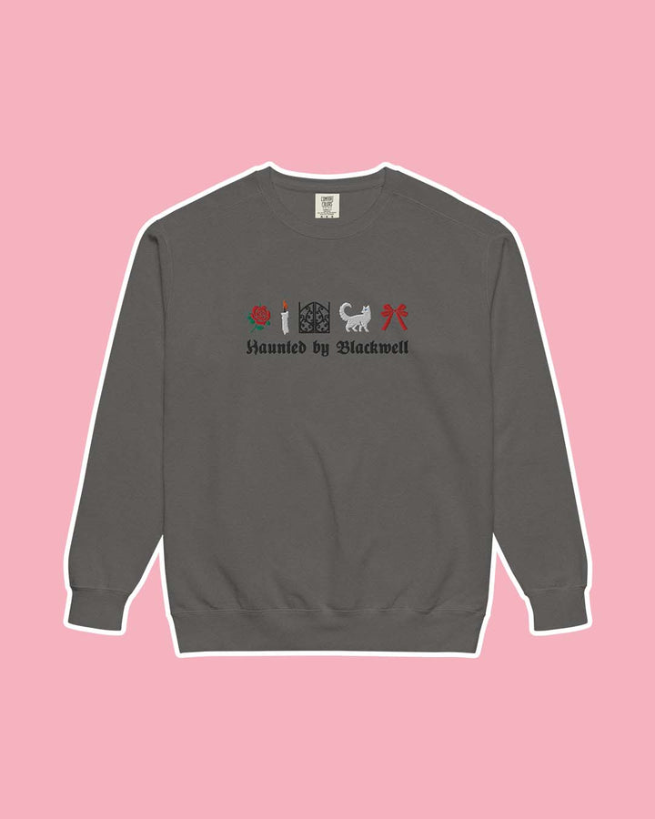 Phantasma sweatshirt for Kaylie Smith fans featuring a gray sweatshirt with embroidered illustrations including a rose, a candle, gates, a white cat, and a red bow with &