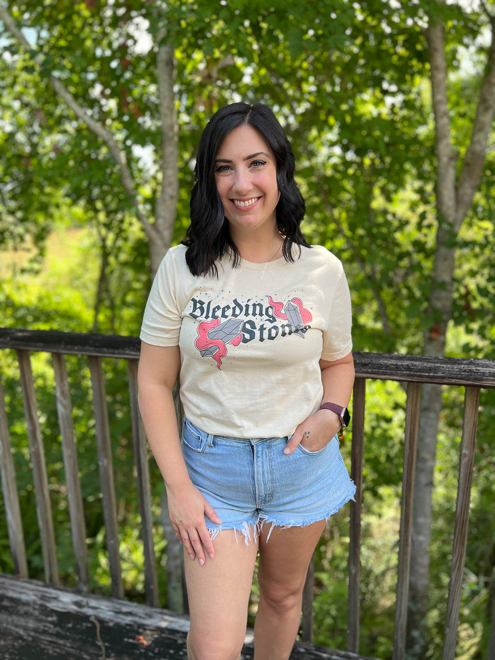 The Sacred Stones t-shirt for Kate Golden fans featuring a design for the phrase 'Bleeding Stones' and a bleeding gem and star embellishments.