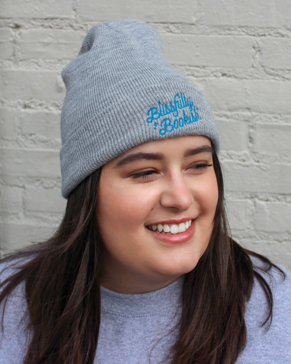 Blissfully Bookish beanie in gray with blue embroidery. 