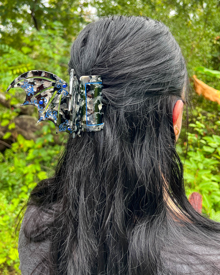 Bookish hair clip in blue and back with blue gem embellishments in the shape of bat wings inspired by ACOTAR.