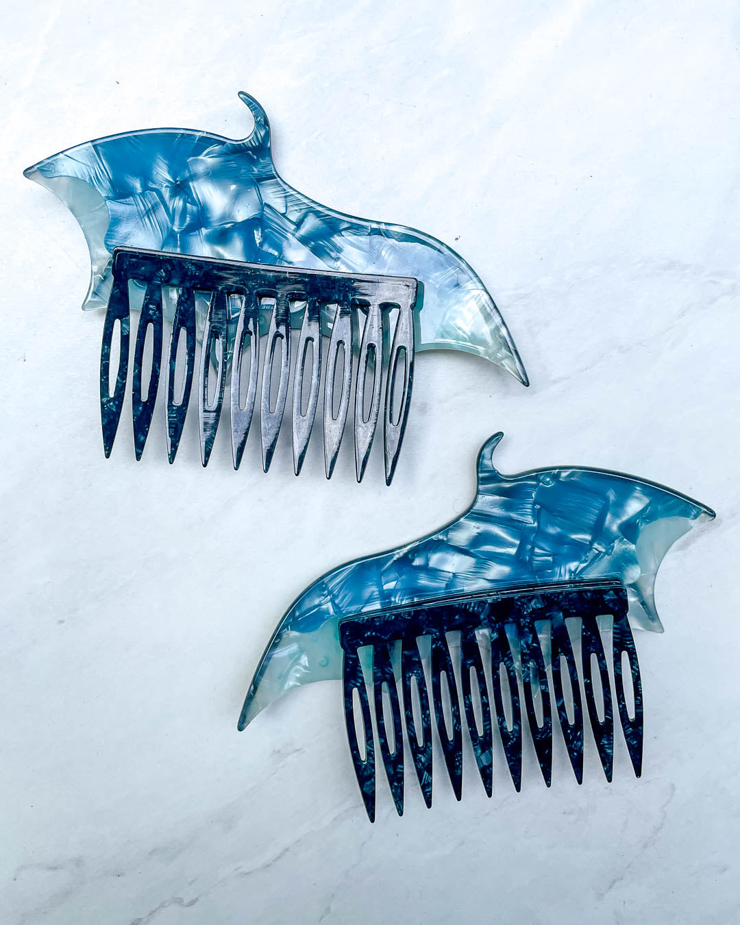 Back of the dragon wing hair accessories featuring a set of blue hair combs and a pearlescent color.