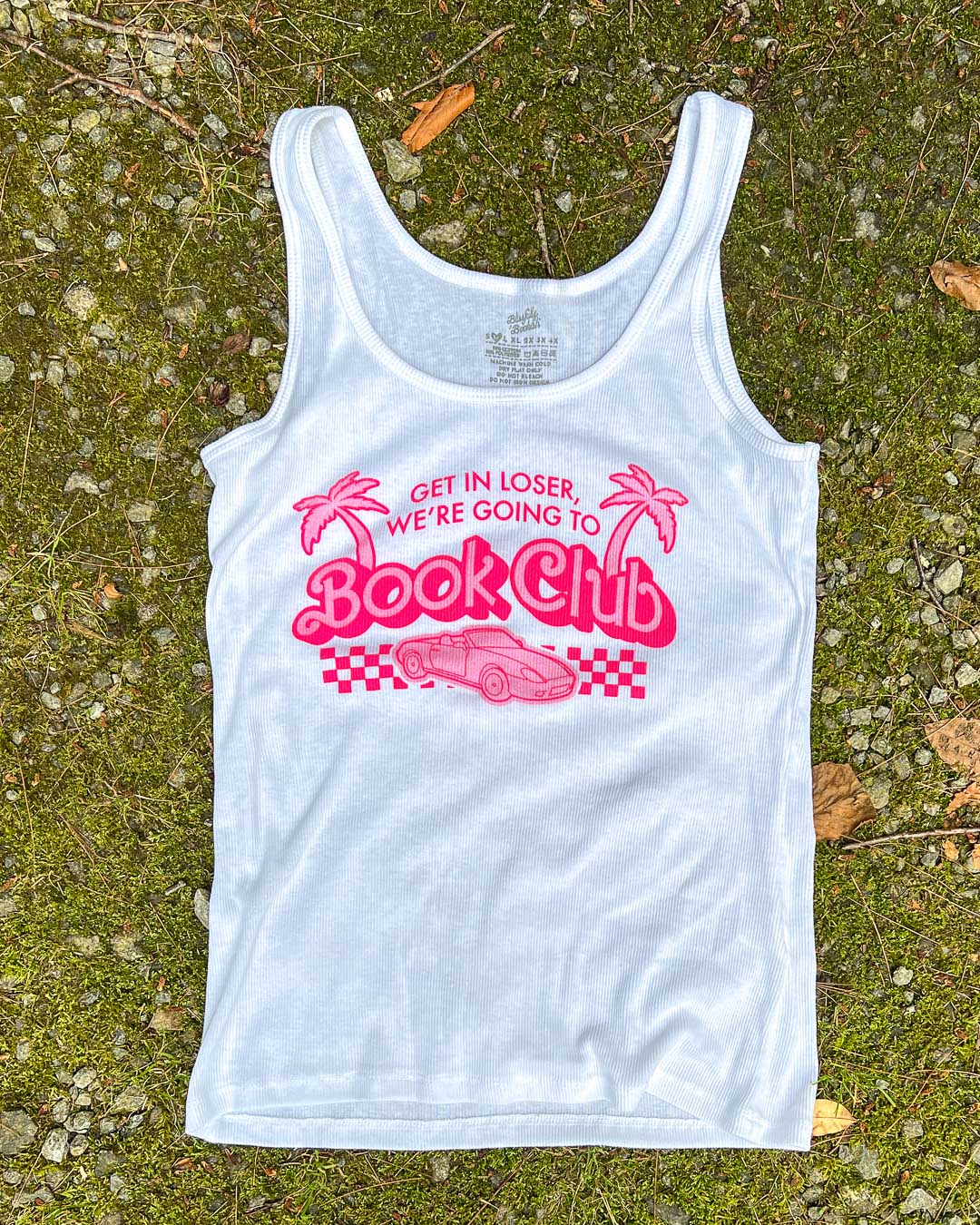 Y2k bookish shirt featuring an illustrated car, a finish line, and palm trees with the line &