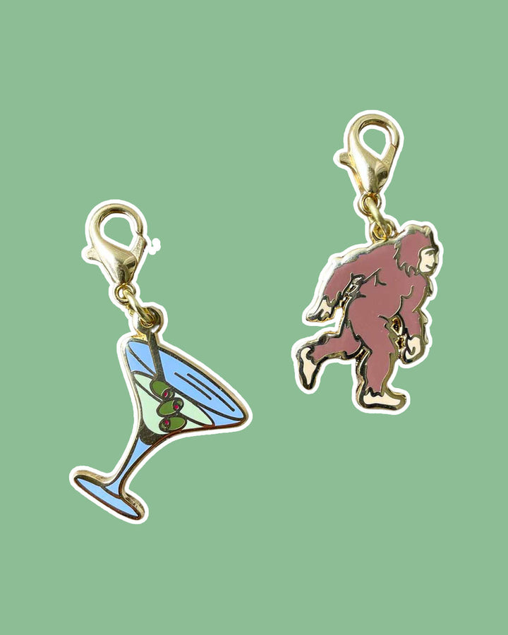 Book Lovers charm set featuring a martini glass and Bigfoot.