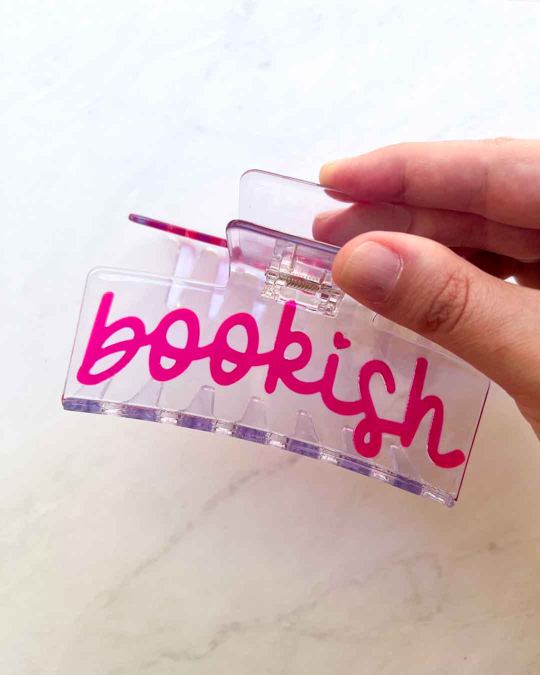 Bookish hair clip featuring transparent acetate material with &