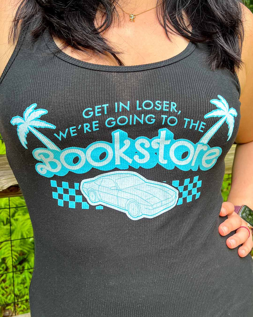 Black bookstore tank top designed with the quote 'Get in loser, we're going to the bookstore' embellished by a car and palm trees.