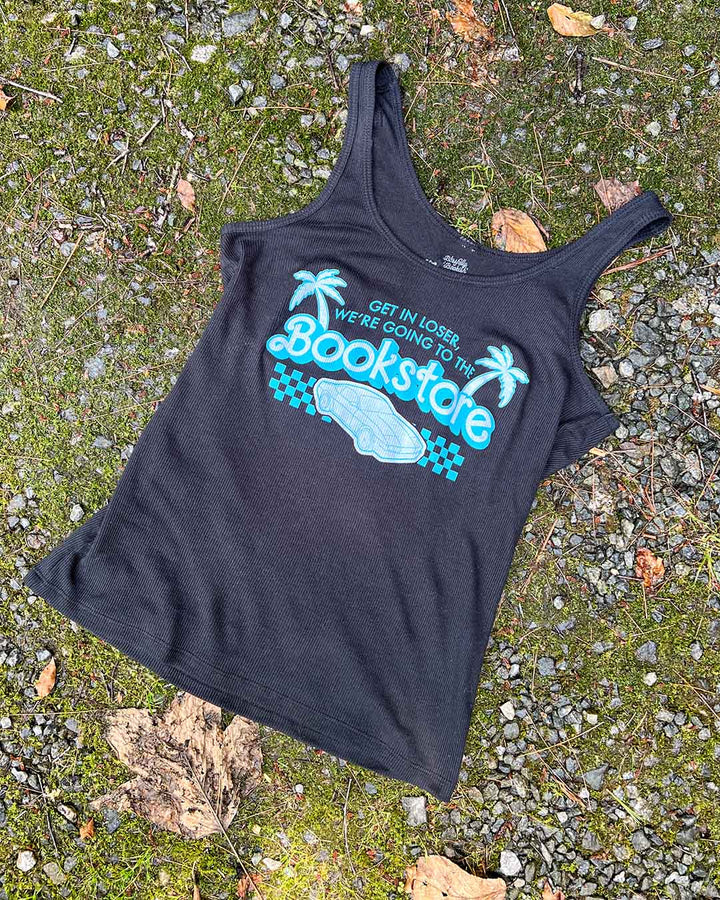 Flat lay of the y2k bookish shirt featuring an illustrated car, a finish line, and palm trees with the line &