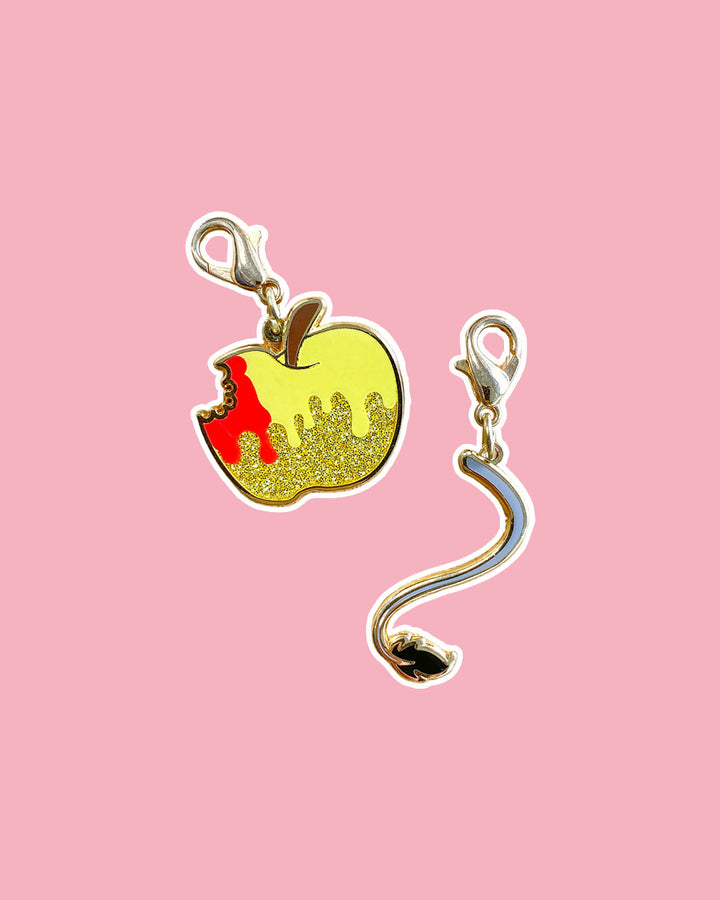 Cruel Prince charm set for Holly Black fans featuring a golden apple with glitter elements with a bite taken out of it dripping with blood and Cardan&