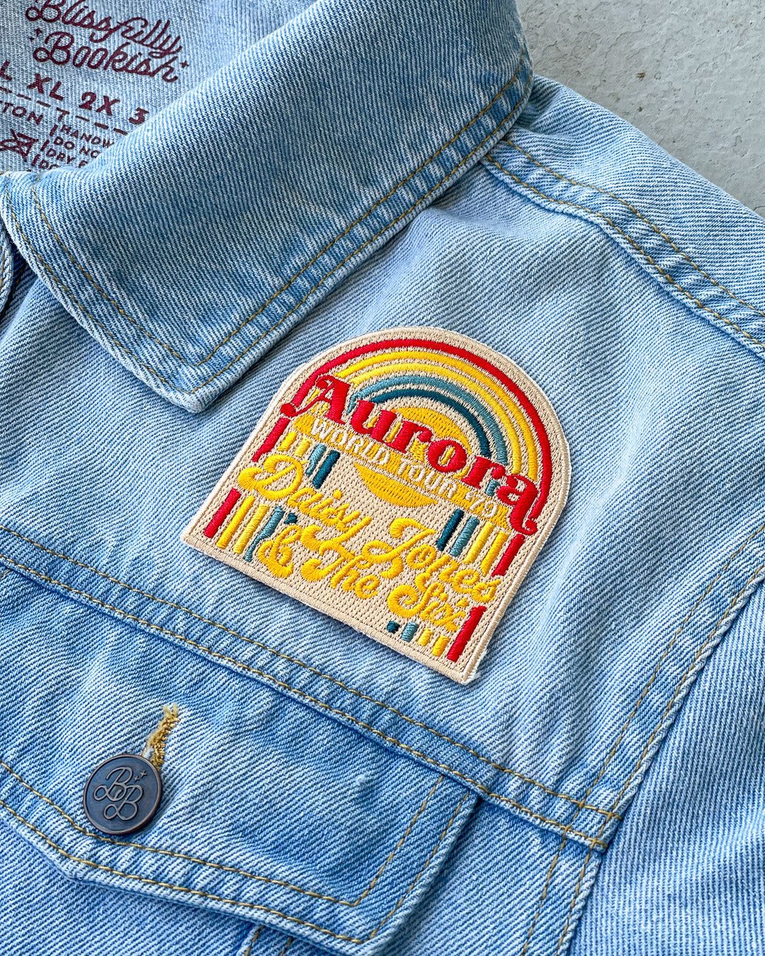 Taylor Jenkins Reid patch featuring a design for the Aurora World Tour &