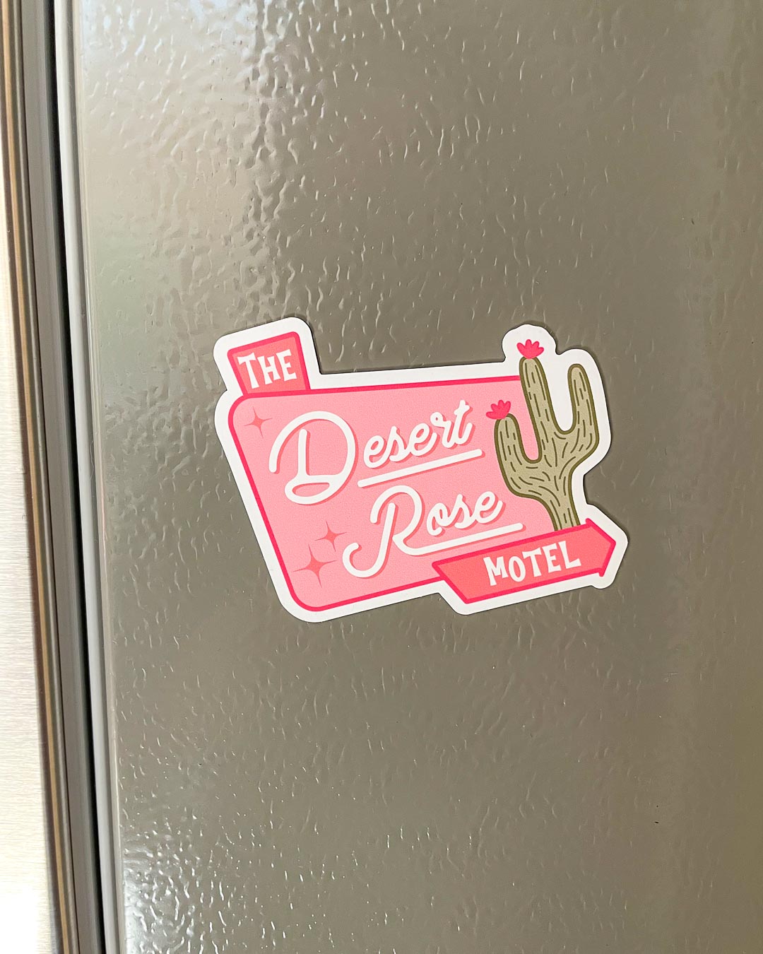 The Desert Rose Motel magnet for Emily Henry fans featuring a sign for the Desert Rose Motel and an illustrated cactus from People We Meet on Vacation.