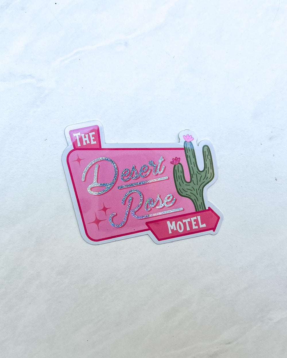 Emily Henry sticker for People We Meet on Vacation fans illustrating a design for The Desert Rose Motel's sign with stars and a cactus detail.