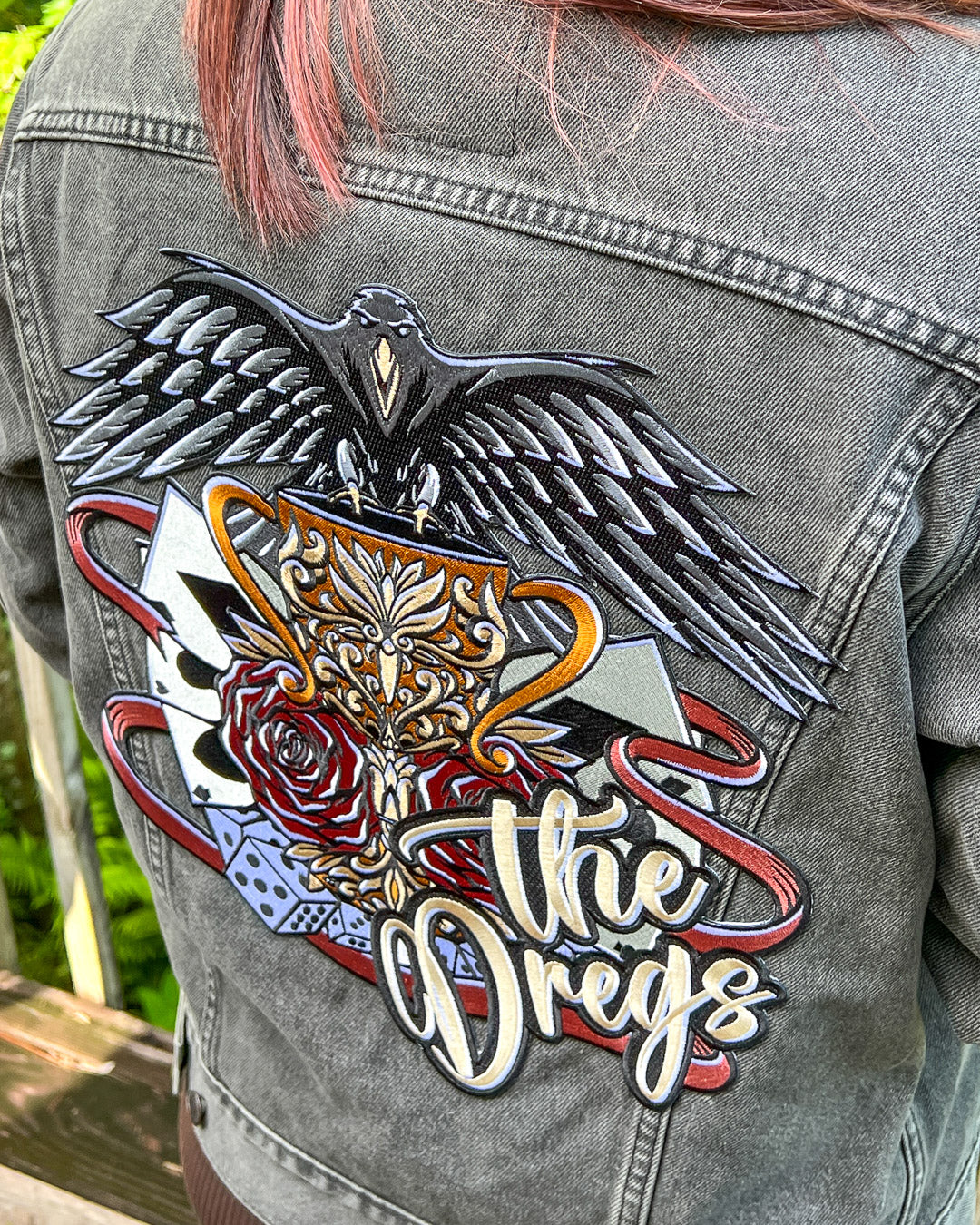 Iron-on patch for Six of Crows fans featuring a design with classic hallmarks of the crows including a crow, dice, and playing cards with &