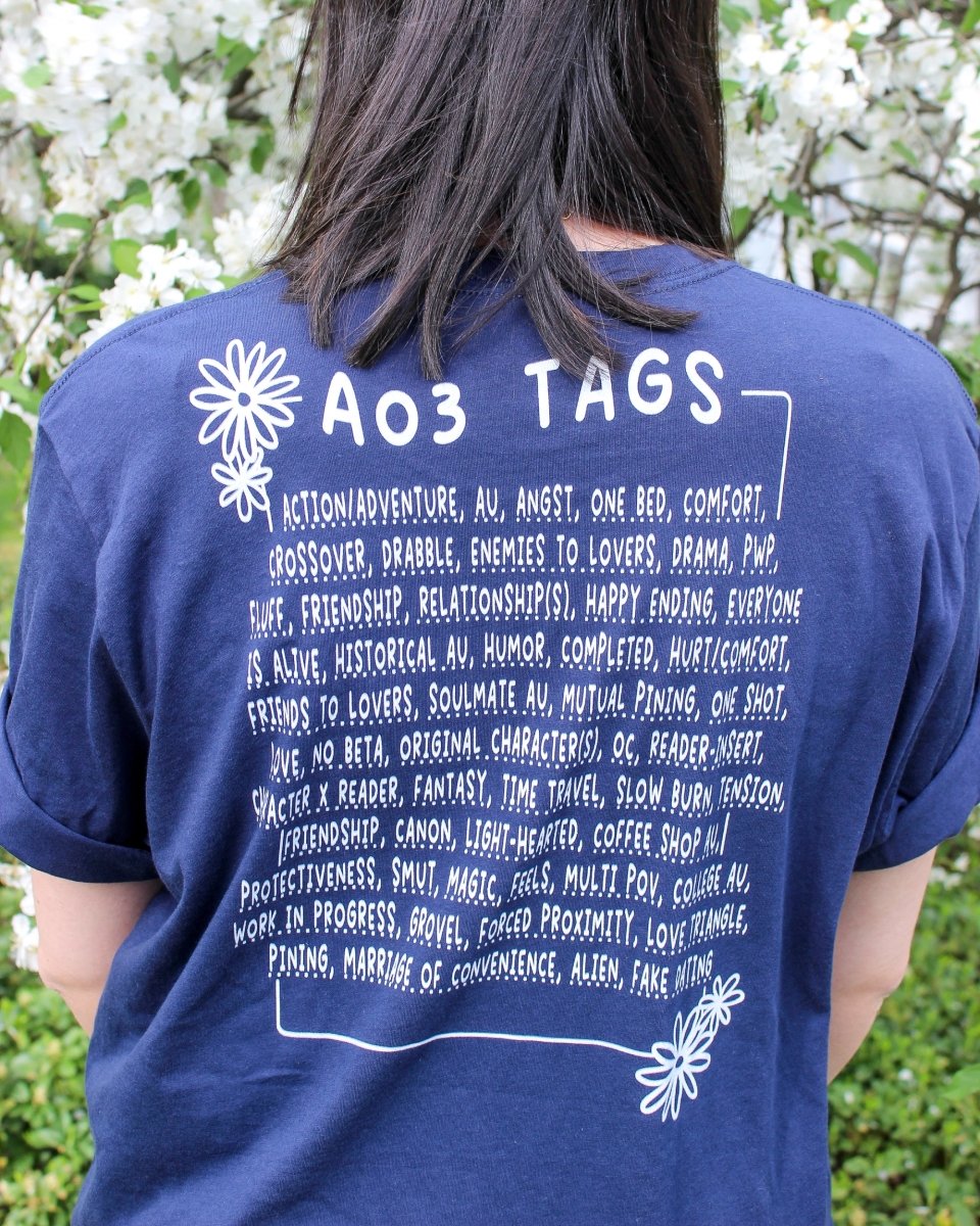 Fanfic t-shirt for readers featuring Ao3 tags on the back including angst, one bed, pining, humor, completed, hurt/comfort, and many more.