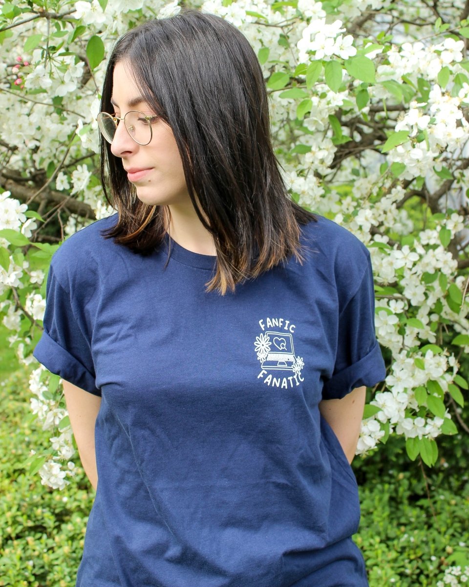 Bookish shirt for fanfic lovers featuring the title 'Fanfic Fanatic' surrounding an open laptop with a heart on it on the left chest.