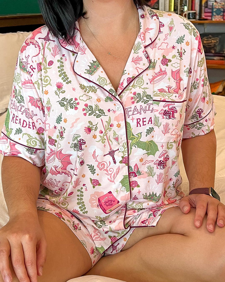 Collared pajamas set for fantasy lovers featuring illustrated designs of flowers, potions, dragons, swords, and crowns.