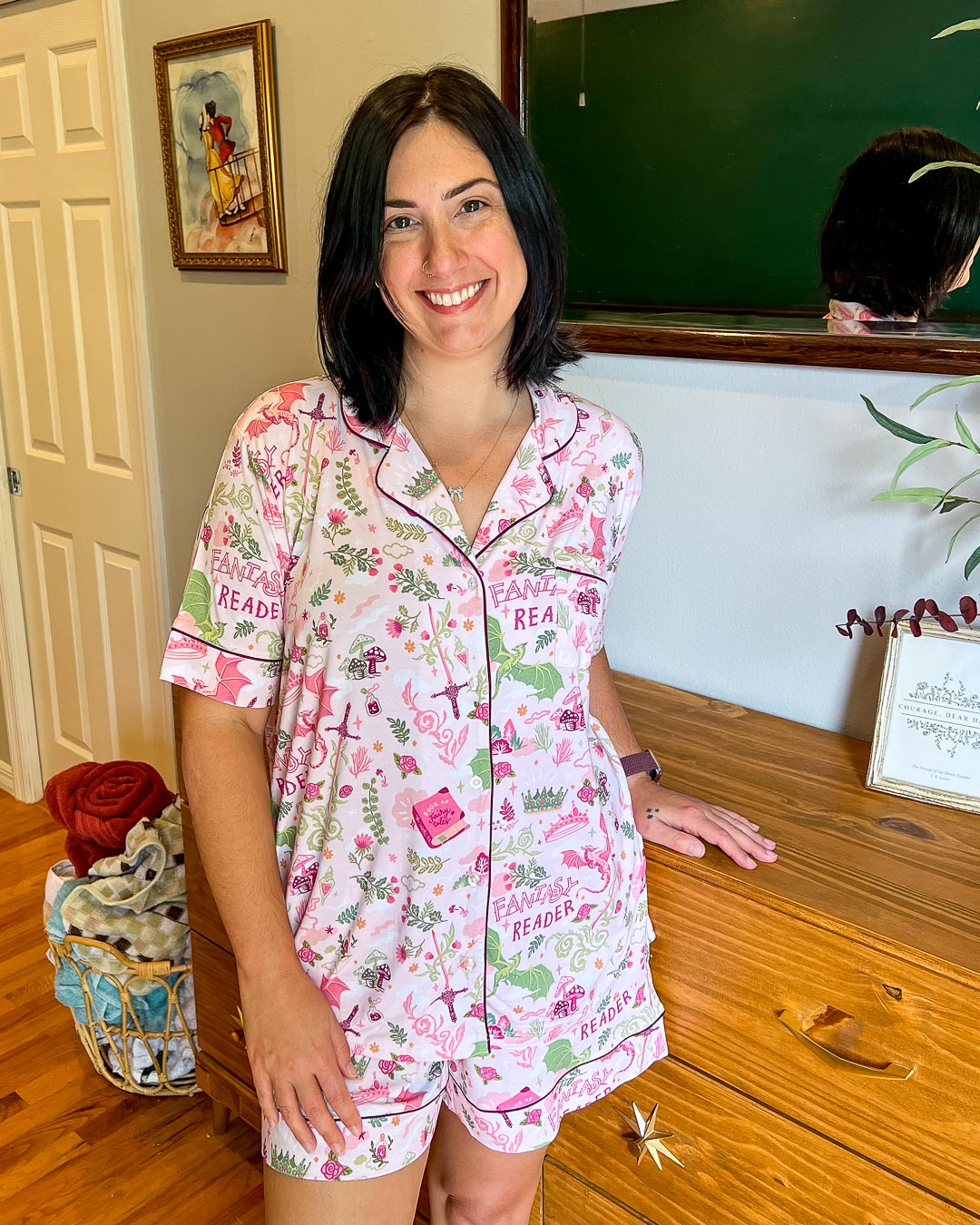 Fantasy pajamas for book lovers with illustrated designs of swords, dragons, mushrooms, flowers, and crowns.