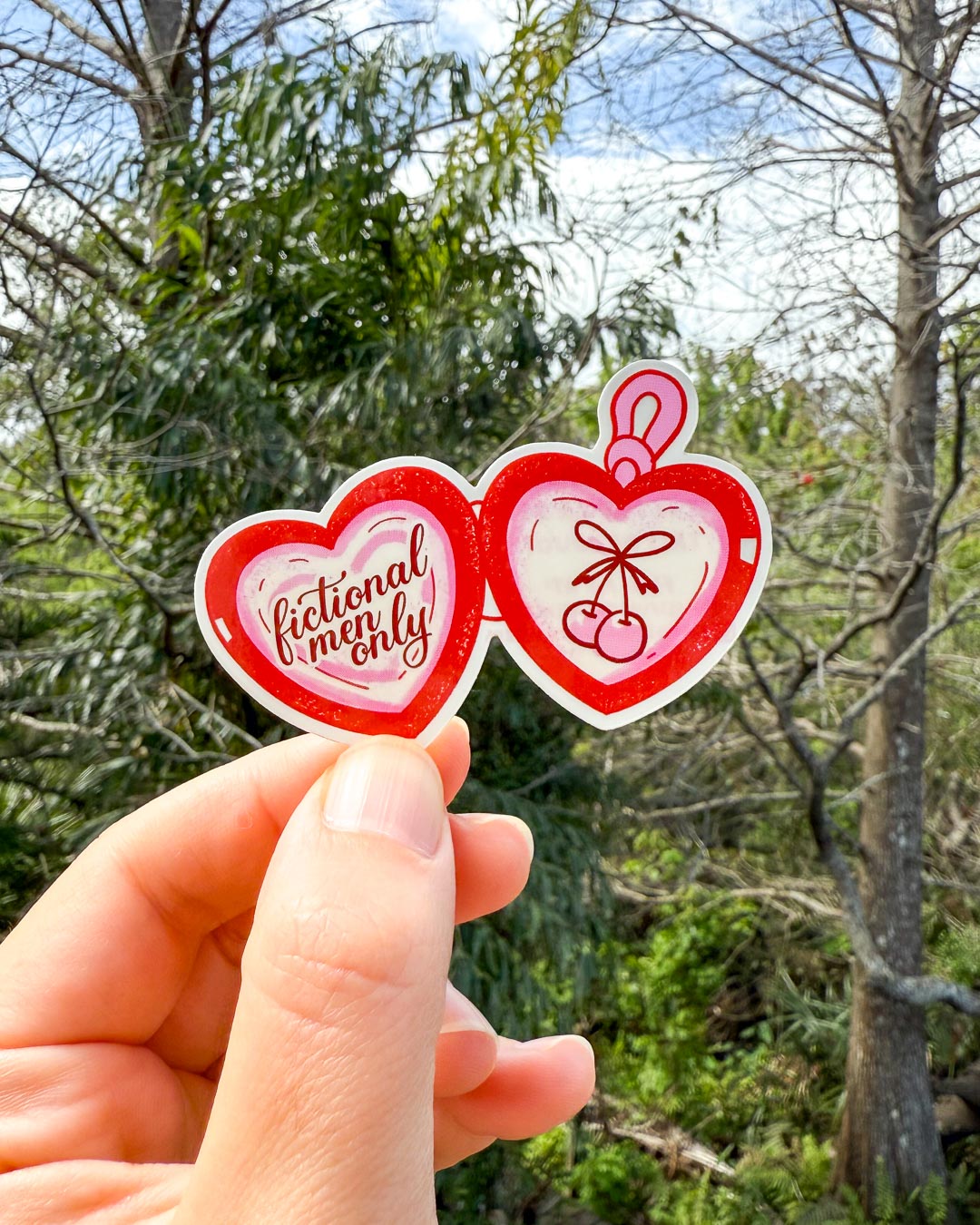Heart-shaped sticker for readers featuring a red locket with &
