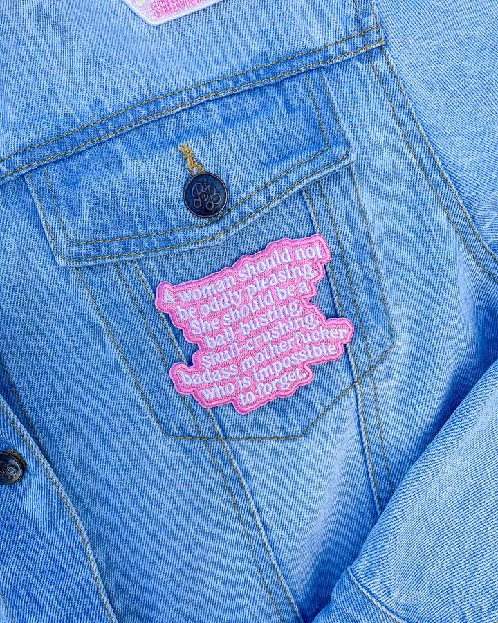 Romance patch for The Four Horseman series fans featuring a pink background and the quote, &
