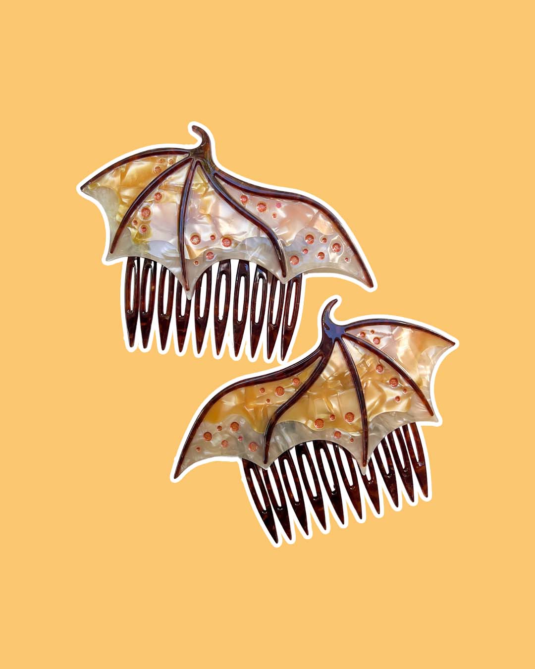 Dragon wing hair combs for fantasy fans in gold featuring engraved embellishments and a pearlescent gold color.