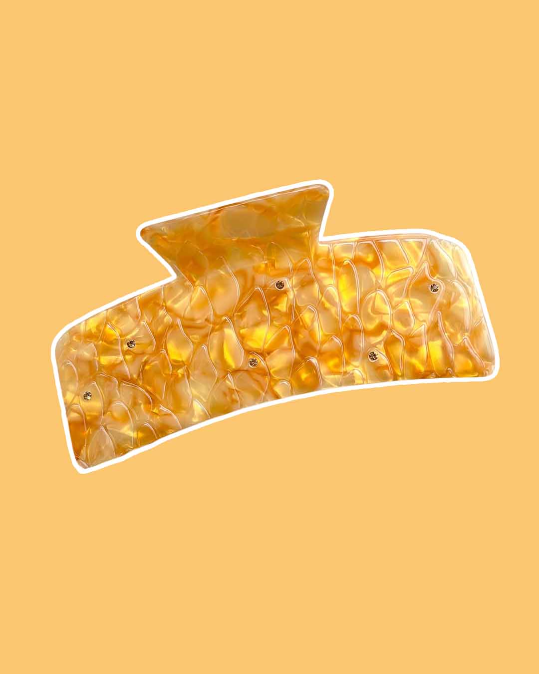 A fantasy hair claw clip crafted in a dual-tone gold pearlescent swirl accented by topaz gems designed to look like dragon scales.