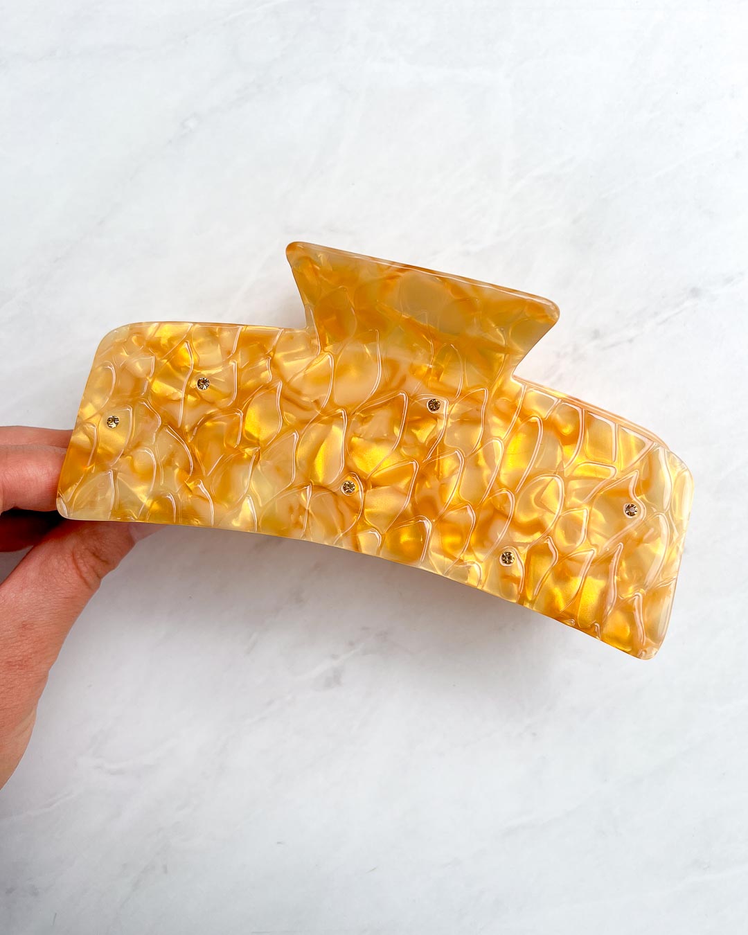 XL dragon scale hair clip for fantasy readers with a dual-tone gold pearlescent swirl design and topaz gem embellishments.