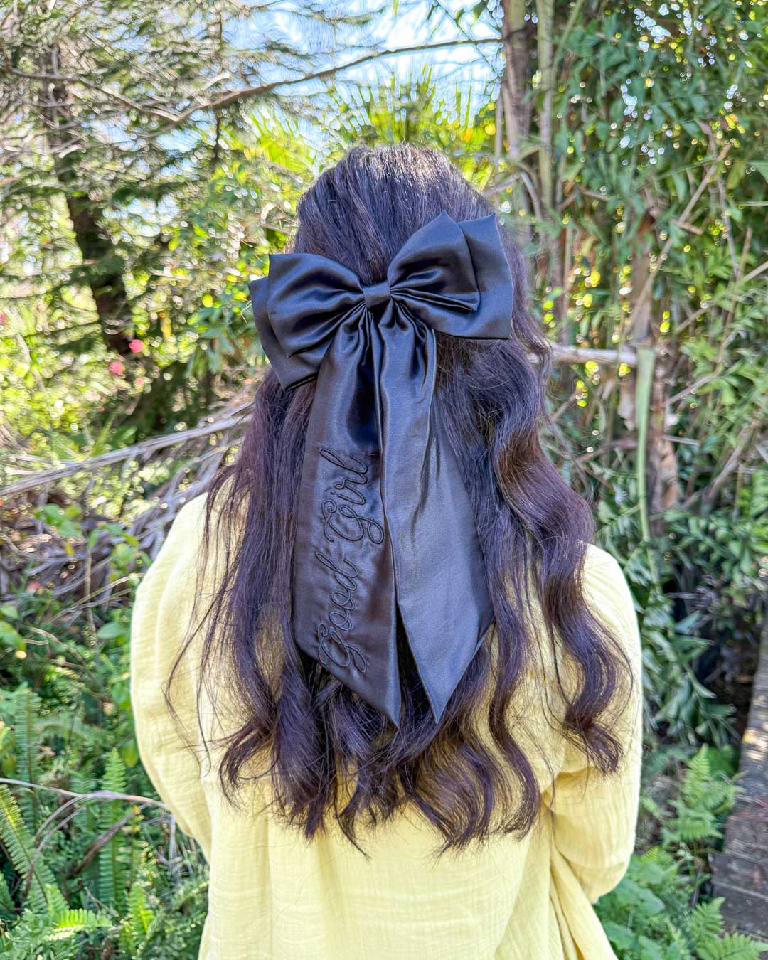 Dark romance hair bow made with black satin and embroidered elements.
