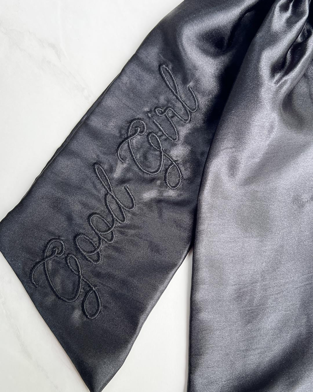 Close up of the embroidered &