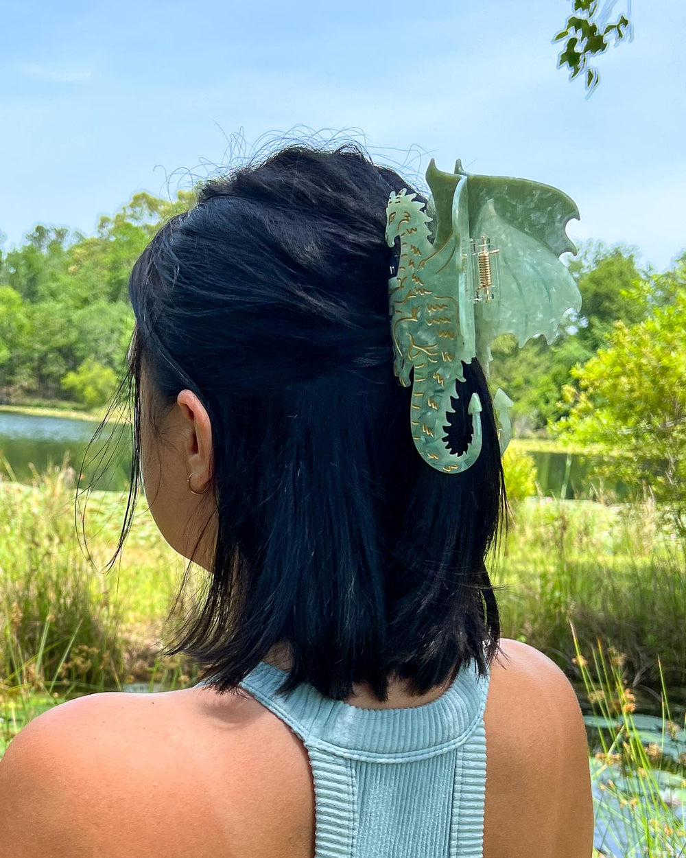 A green and gold detailed bookish hair clip for fantasy lovers in the shape of a dragon.