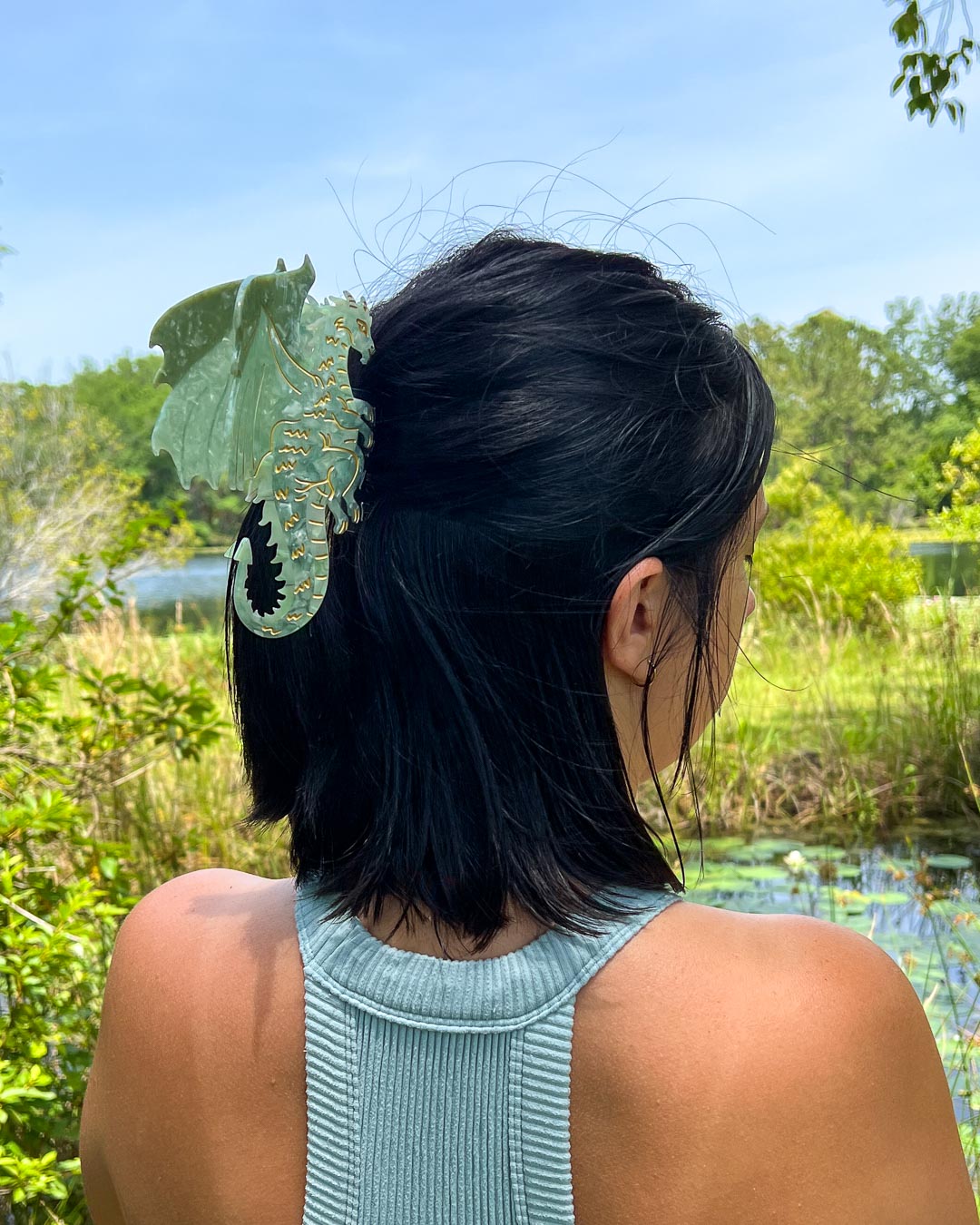 Bookish hair accessory in the shape of a dragon with green tones and gold etching details for fantasy readers.