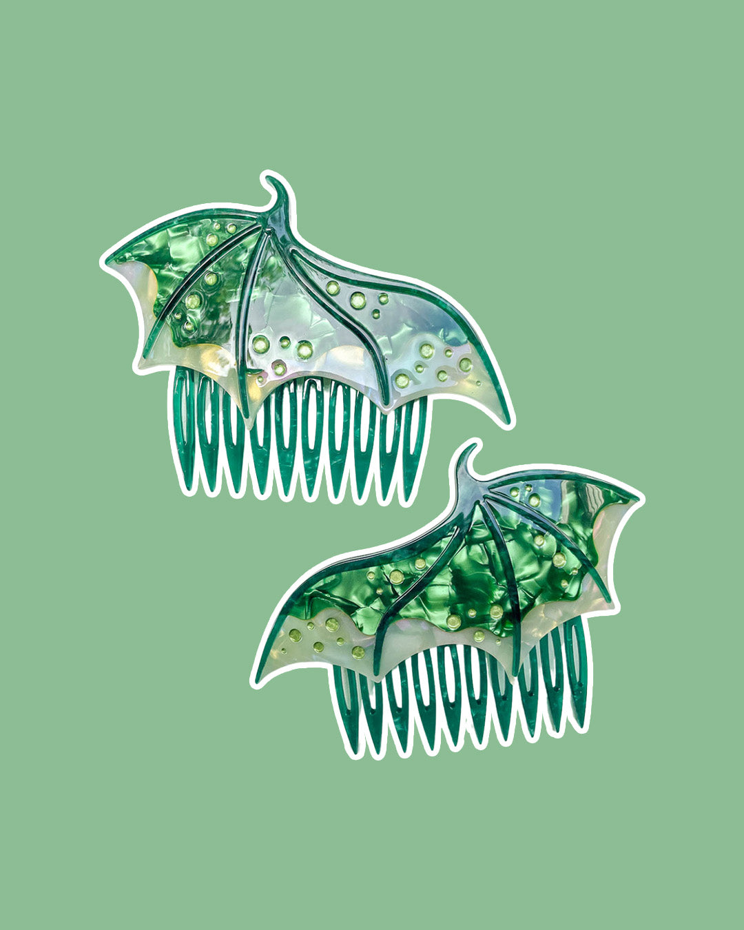 Dragon wing hair combs for fantasy fans in green featuring engraved embellishments and a pearlescent green color.