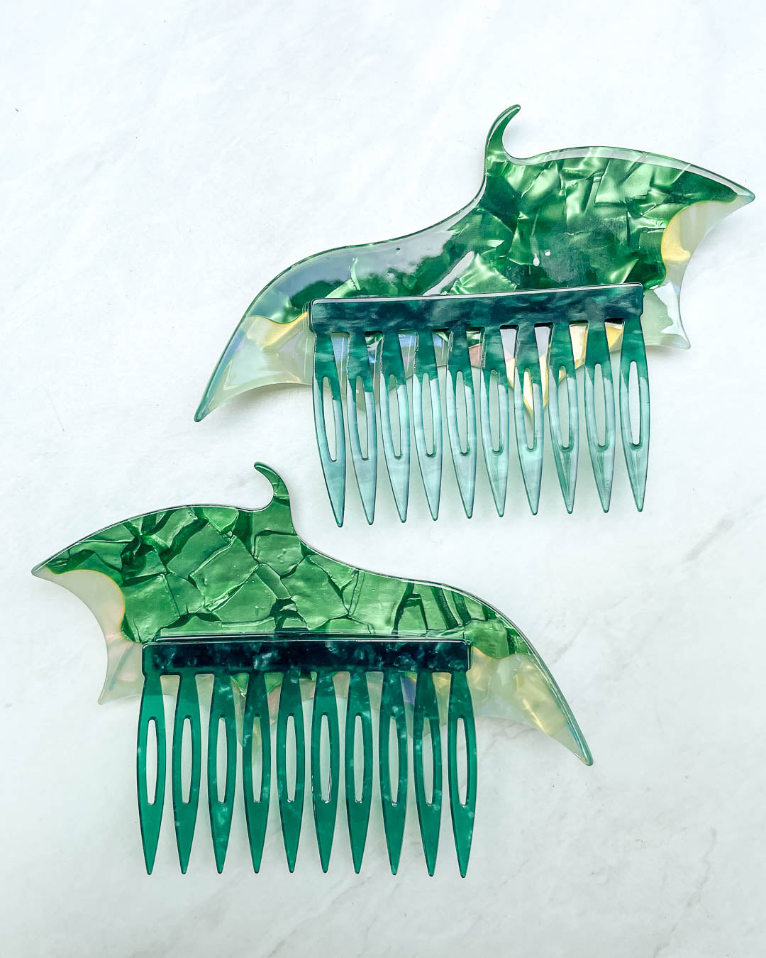 Back of the dragon wing hair accessories featuring a set of green hair combs and a pearlescent color.