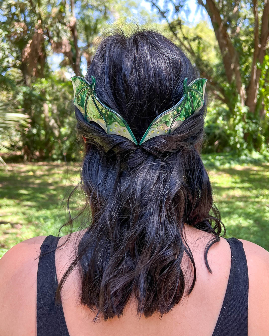 Fantasy hair combs featuring large combs in the shape of dragon wings in green with engraved embellishments and a pearlescent color.