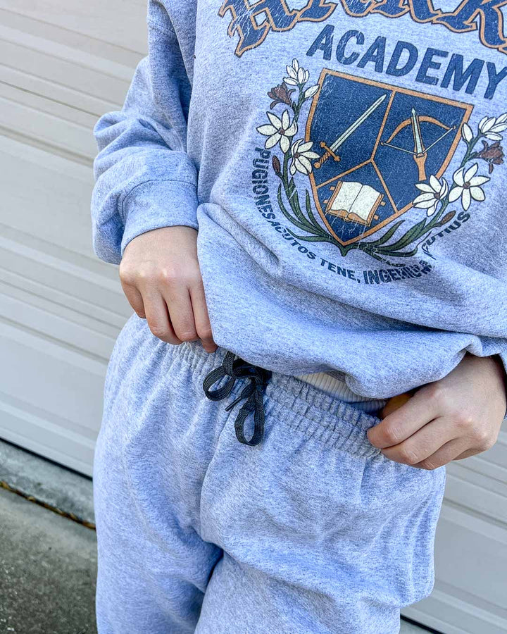 Close up of the Harker Academy sweatshirt and sweatpants for fantasy readers.