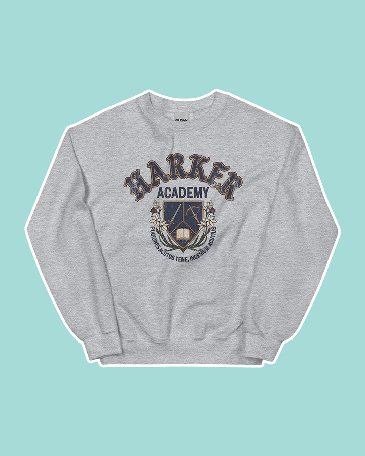 Gray crew neck sweatshirt on a light blue background featuring a Harker Academy logo for Kate Golden&