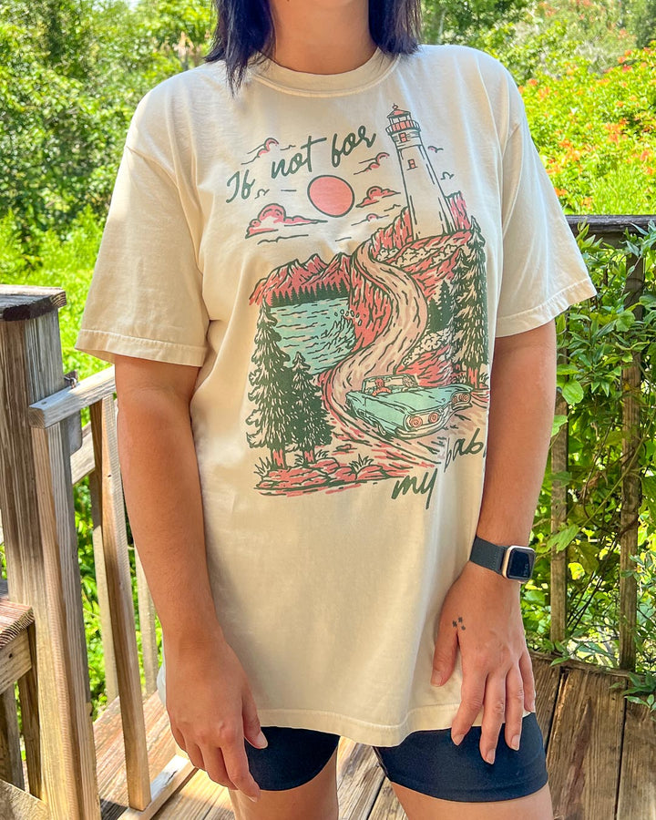 If Not For My Baby t-shirt featuring an illustrated, multi-colored landscape of a lighthouse, vintage car, pines, water, mountains, and a setting sun.