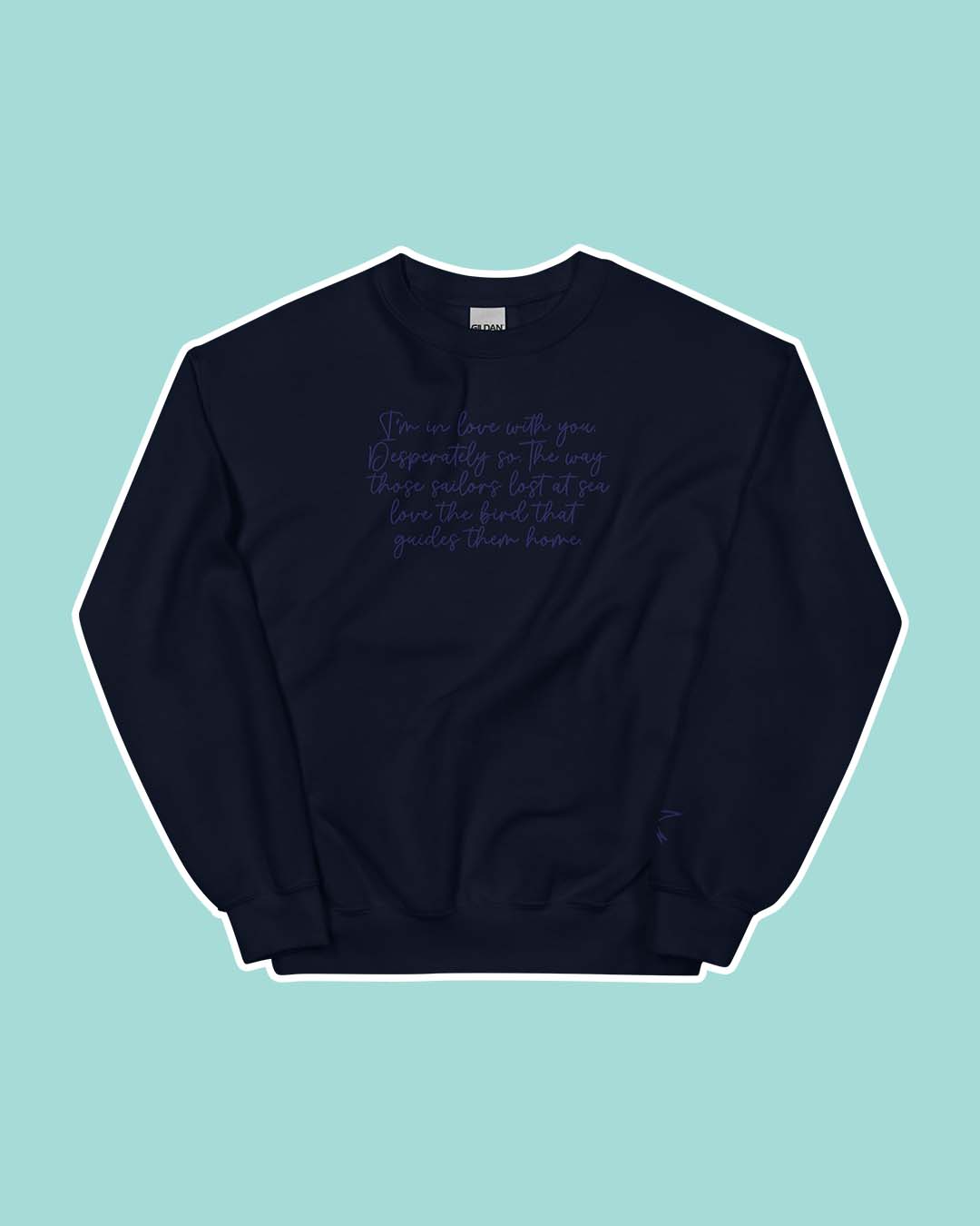 A Dawn of Onyx sweatshirt with the quote 'I'm in love with you. Desperately so. The way those sailors sea love the bird that guides them home' embroidered on the front.