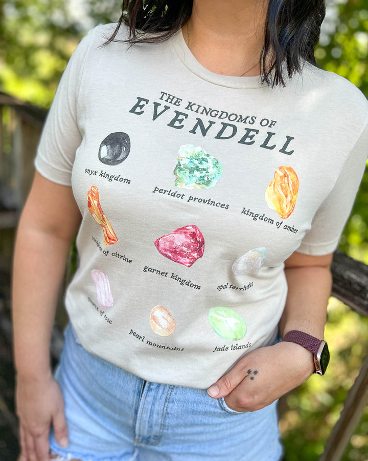 Kate Golden shirt for A Dawn of Onyx fans featuring a design for all the Kingdoms of Evendell and their associated gems, including onyx, peridot, amber, citrine, garnet, opal, quartz, pearl, and jade.