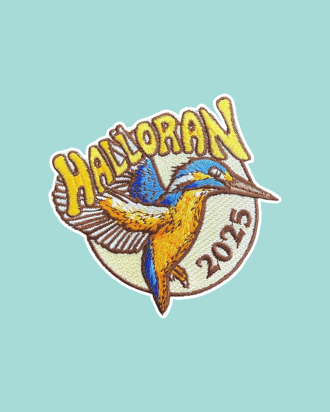If Not For My Baby patch for Kate Golden fans featuring a blue and yellow kingfisher with its wings spread side and 'Halloran' written in all caps over it with '2025' following the curve of the edge of the patch.